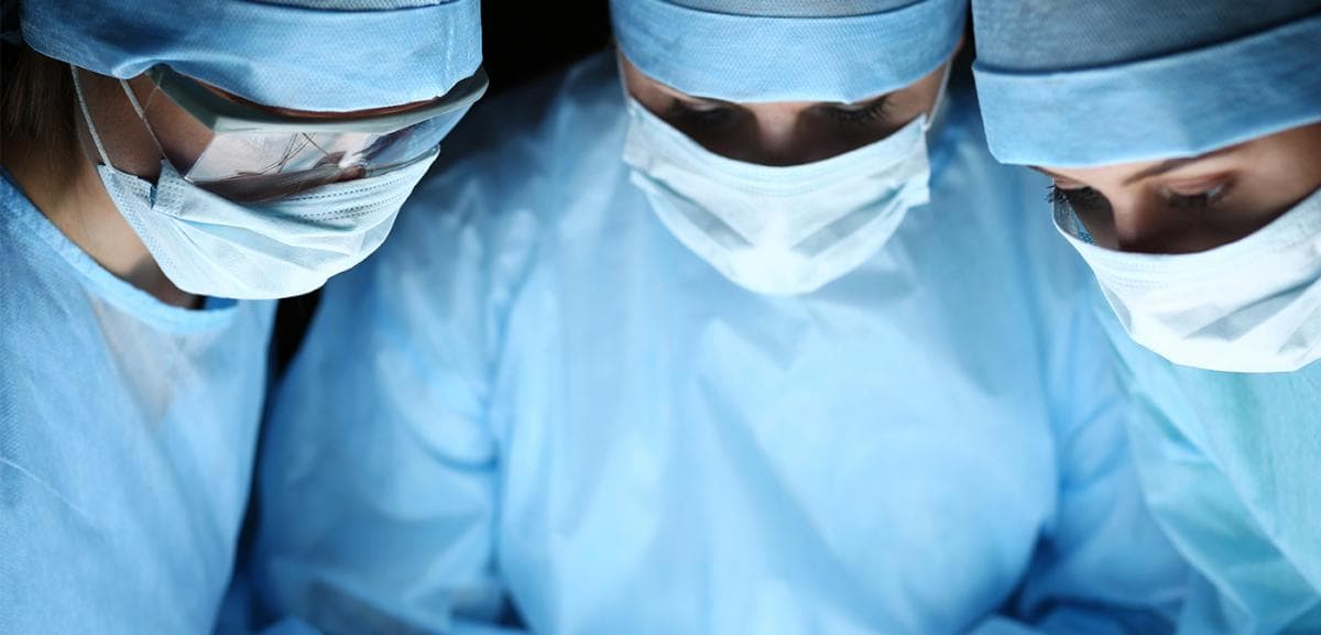 Hero image: Three surgeons standing together